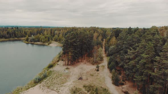 Drone flying over lake in summertime Sweden alt