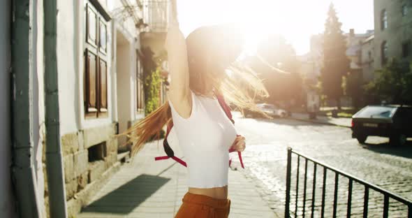 Female Tourist with Backpack in City