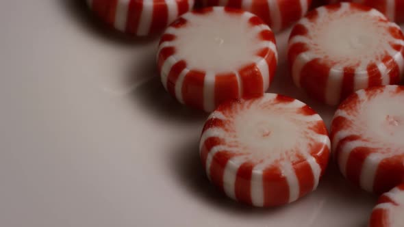 Rotating shot of peppermint candies  alt