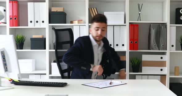 Young Adult Businessman Coming in Workplace in Modern Office