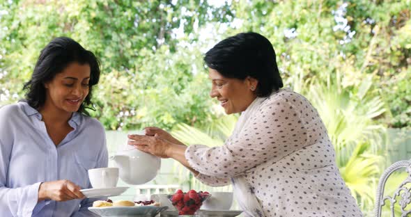 Mother and daughter having tea 4k alt