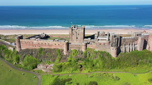 Aerial footage the famous Bamburgh Castle, a castle on the northeast coast of England alt