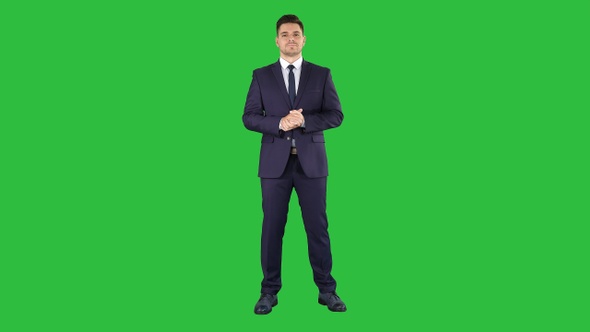 Businessman Listening on a Green Screen, Chroma Key alt