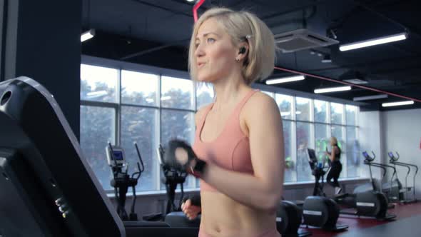 Young woman training on treadmill