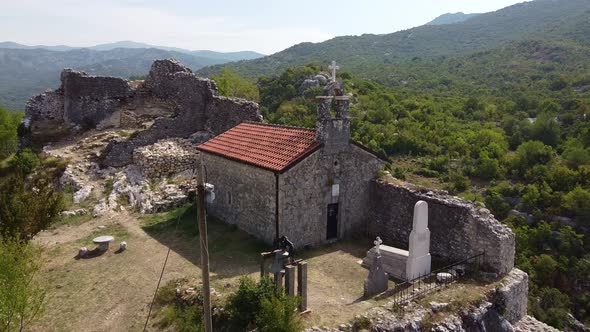Flying Away From Ancientt Church Located on Rock Top
