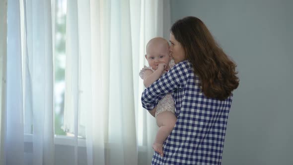 Mother Kissing Little Baby Daughter With Love and Whispering Tender Words to Her alt