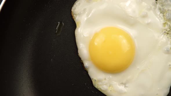Tracking of Close up of a fried eggs on the pan