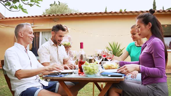 Mature People Celebrating a Bbq Party Sharing His Food with His Friends alt