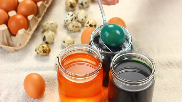 Young Child Caucasian Ethnicity Preparing for the Religious Holiday Easter Dyeing Eggs with Spoon alt