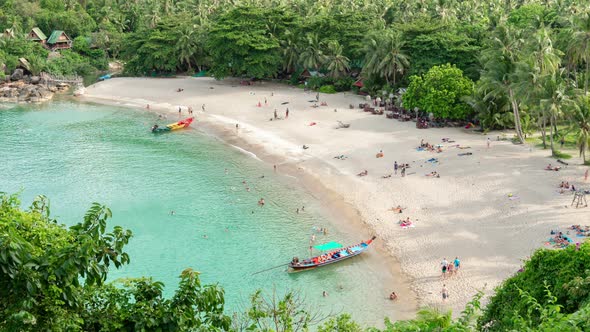 Aerial view of sandy beach with people in sea bay with transparent blue water in summer alt