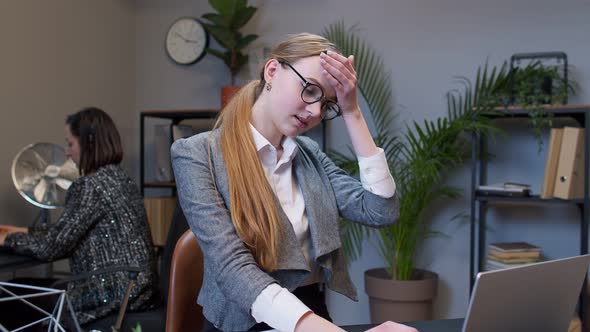 Bored Young Woman Boss Doing Face Palm Gesture While Developing New Project on Laptop Computer alt