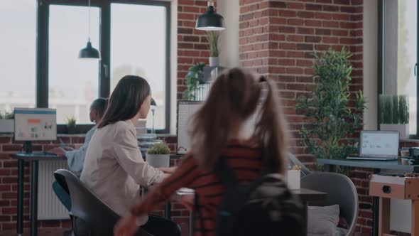 Little Girl Returning Back From School to Mother Workplace Staying at Parent Work alt