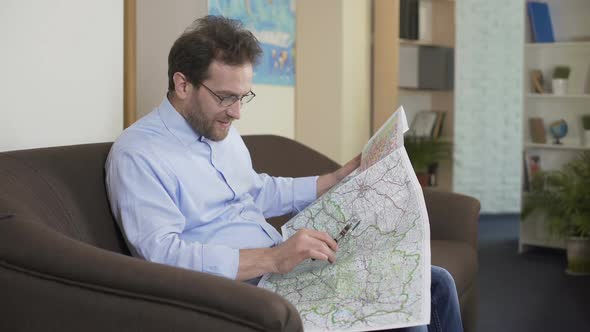 Globetrotter Planning Trip, Adult Man Looking at Map, Vacation and Traveling alt