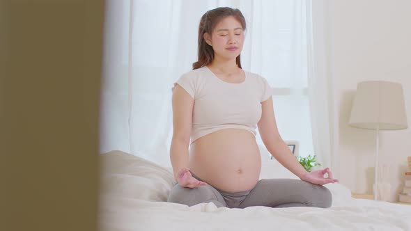 Happy Calm Pregnant Woman deep breath with fresh air do yoga lotus pose comfortable alt