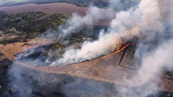 Aerial top view of smoking wildfire. Large smoke clouds  alt