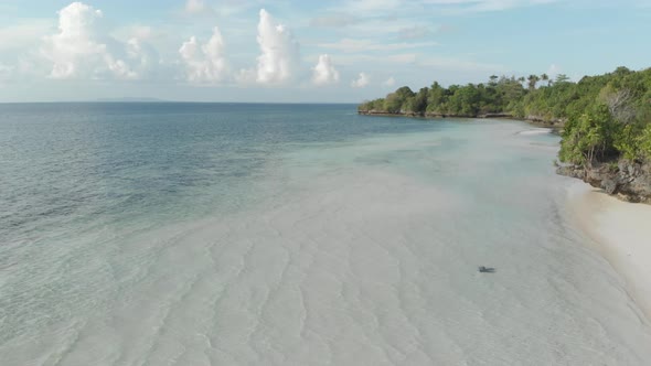 Aerial: Flying over tropical beach turquoise water coral reef , Tomia island Wak alt