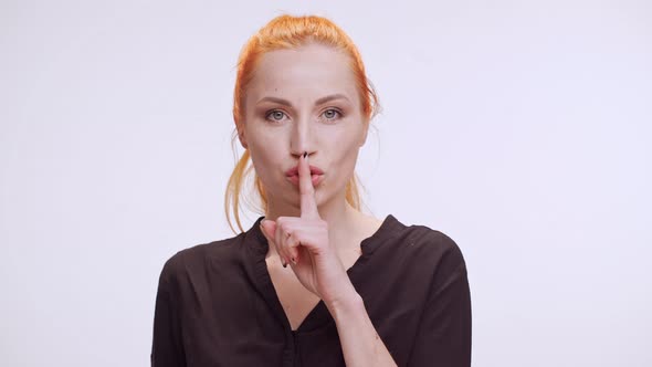 Beautiful Middleaged Caucasian Woman with Orange Colored Hair and Dark Brown Shirt Standing on White alt