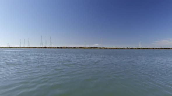 Low Aerial Over Water Approaching Power Lines alt