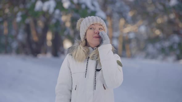 Portrait of Cute Girl in Warm Winter Clothes Screaming Calling Someone alt