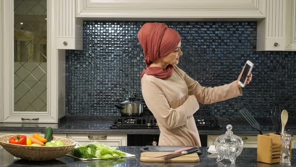 Oriental Lady Stands Half Face and Makes Selfie Against Food alt