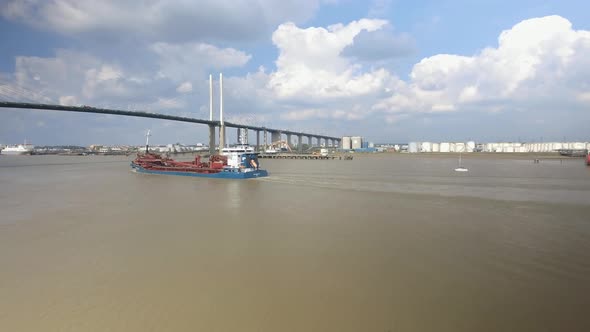 Large Boat and Yacht About to Travel Under Suspension Bridge alt