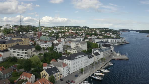 Seaside Town Of Arendal By The Norwegian Coast In Agder County, Norway.  - aerial drone alt