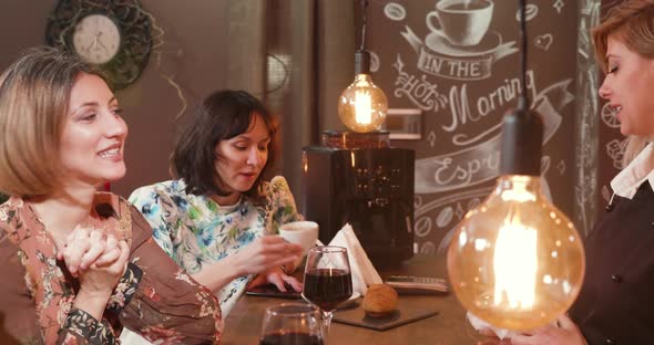 Beautiful Young Woman Talking To a Female Bartender alt