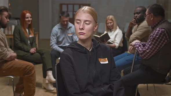 Troubled Young Woman Looking Pathetically at Camera alt