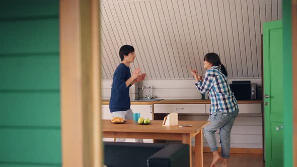 Loving Couple Cheerful Guy and His Pretty Girlfriend Are Having Fun in Kitchen in Beautiful House alt
