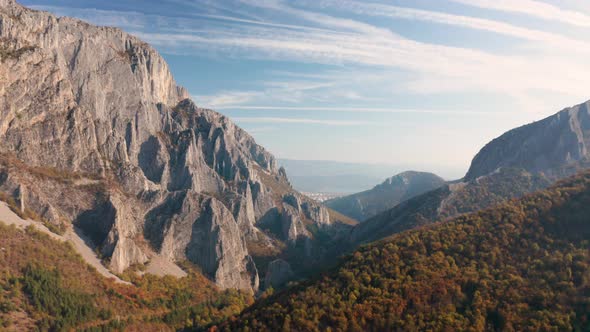 Drone flight over autumn rocky mountain in the morning light alt