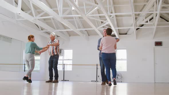 Caucasian senior couples spending time together in a ballroom And dancing alt