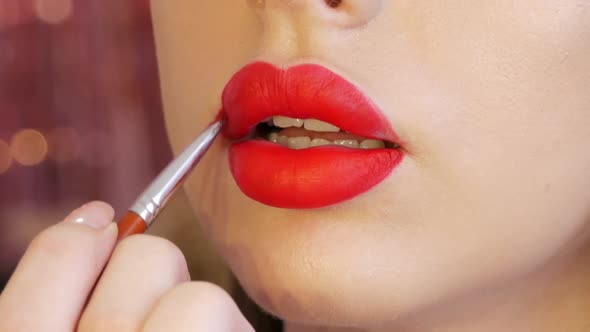 Bright Lip Makeup Big Beautiful Lips are Painted with Red Lipstick with a Special Brush in a Beauty alt