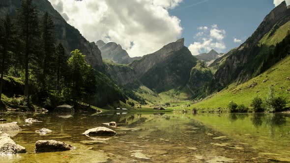 Timelapse Clouds Float over Lake Seealpsee in Swiss Alps alt