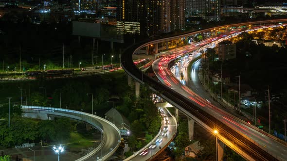 Highway interchange junction and traffic during rush hour in Bangkok outskirt, at night