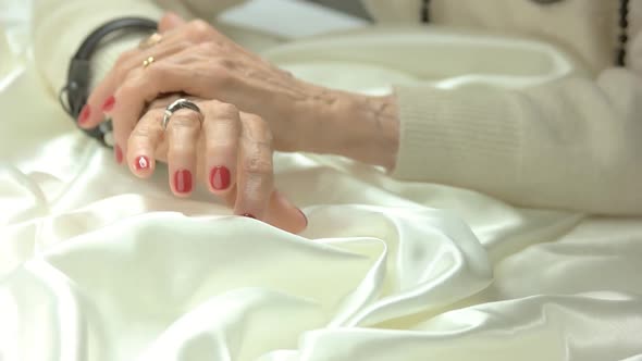 Senior Woman Manicured Hands with Jewelry. alt