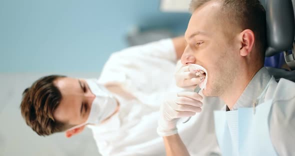 Dentist and Patient During an Orthodontic Treatment alt
