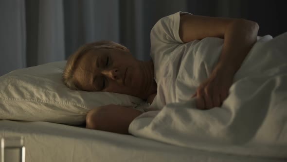 Bad Looking Senior Woman Sleeping Seeing Nightmares and Feeling Pain in Dream alt