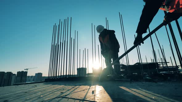 Construction Worker Is Breaking Concrete with a Jackhammer. Construction Worker at a Construction alt