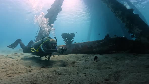 A Scuba Diver in a Safe Diving Suit Captures the Beauty of the Underwater World