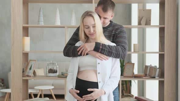 Young expectant parents hug  happy  waiting for birth of baby.