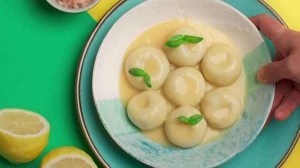 Flat Lay Food Video the Cook Puts Plate of Cooked Potato Dumplings to the Table  Prores 422