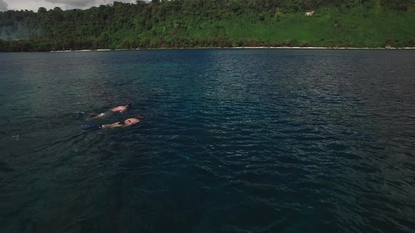 Snorkeling in Tropical Sea, Aerial View of Couple in Lagoon Near Exotic Island alt