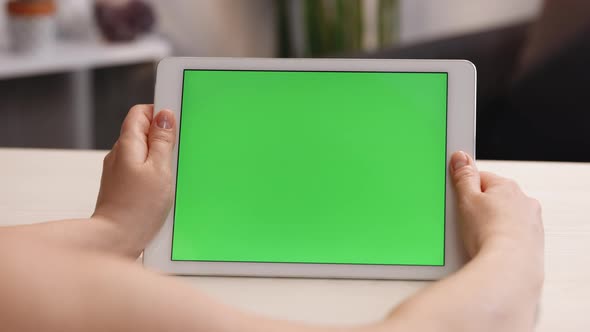 Close up Horizontal Hands Holding Tablet Computer With Green Screen for Copy Space