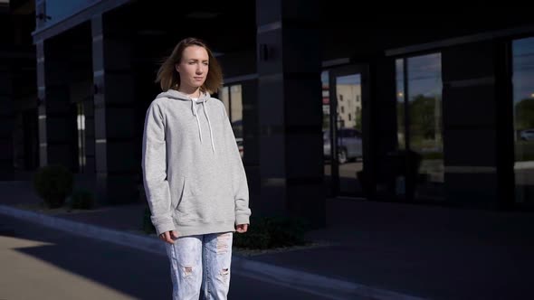 A Young Girl in a Hoodie and Jeans Travels Through the City Streets on a Gyrocopter. alt