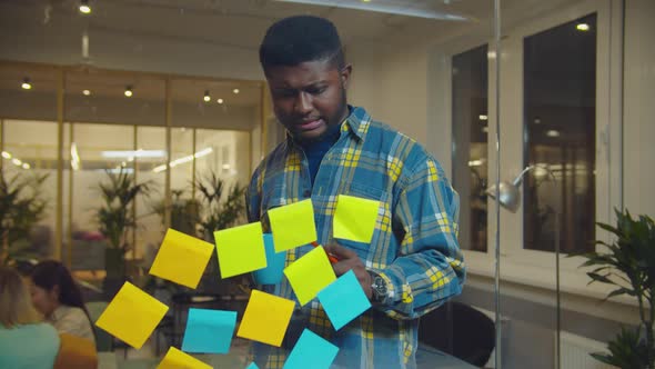 Thoughtful Manager Creating Business Plan in Office alt