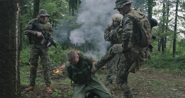 Soliders Capturing Terrorist and Conducting Antiterrorist Millitary Action in Dense Forest with alt