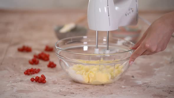 Woman whisk soft butter with sugar. Mixing cookie ingredients in bowl for baking.	