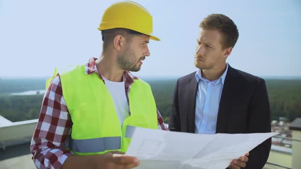 Male Director in Suit and Construction Manager Discussing Building Plan, Work