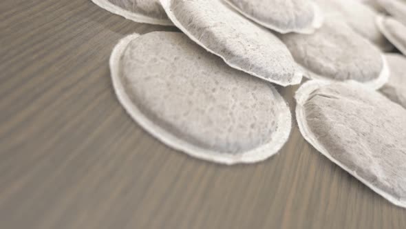 Coffee pod lot  on wooden table dolly slider close-up 4K 2160p UHD footage - Dolly sliding to lot of alt