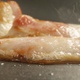 Slice Of Bacon On A Frying Pan A Closeup Shot On Red Camera - VideoHive Item for Sale
